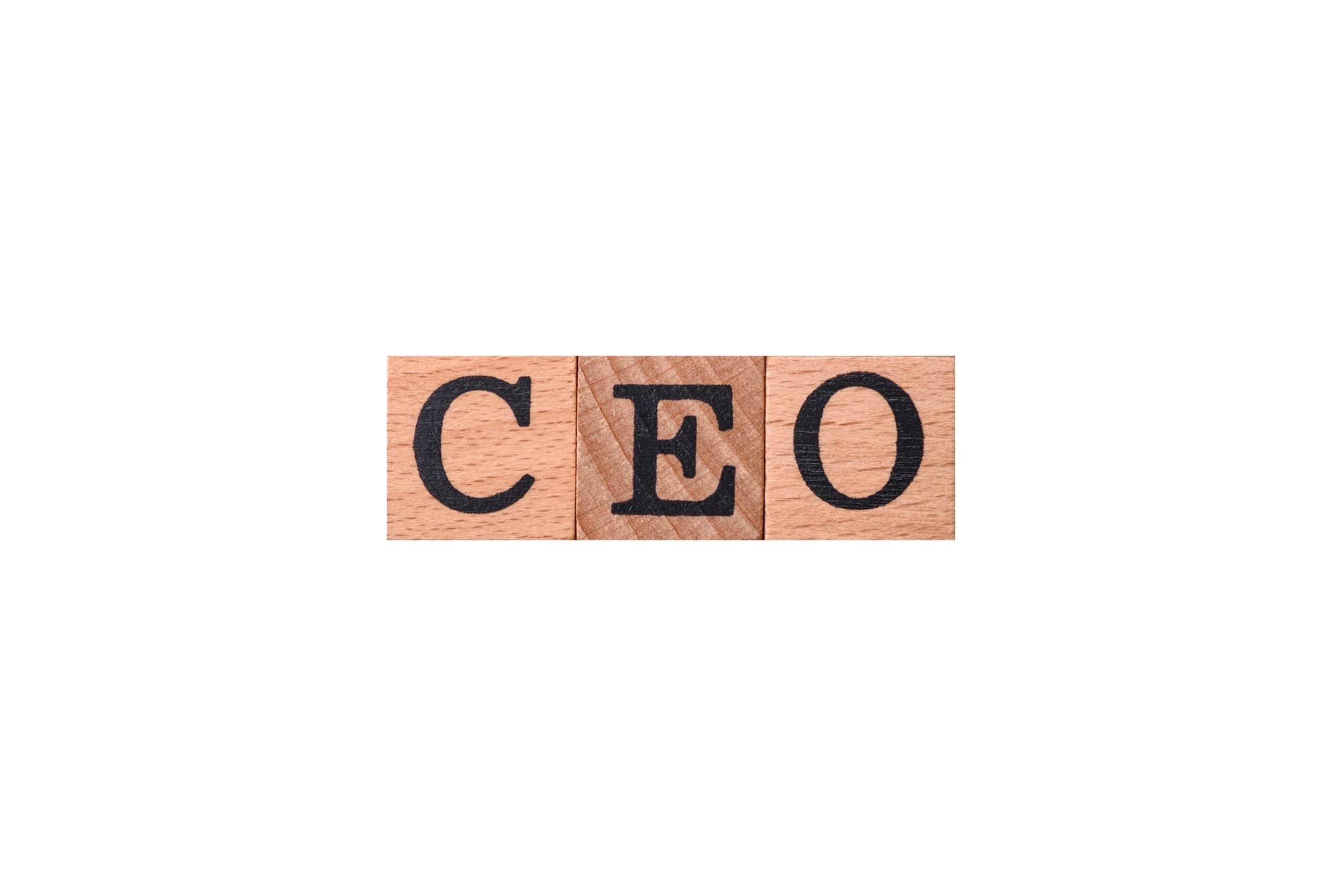 The inscription ceo in wooden cubes on a dark concrete background